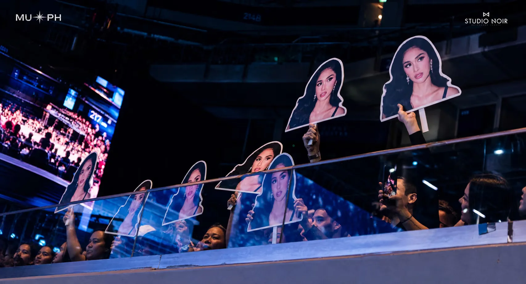 Fans holding cut-out portraits of Nicole Borromeo at Miss Universe Philippines